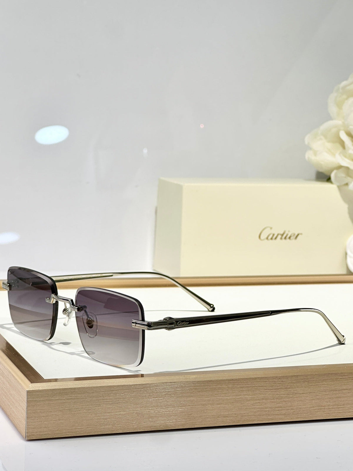 CARTIER C DE RIMLESS SQUARE FRAME SUNGLASSES CT0610S IN METAL