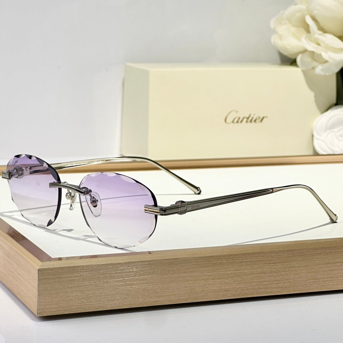 CARTIER C DE RIMLESS ROUND FRAME SUNGLASSES CT0611S IN METAL